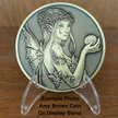 Gold metal coin with fairy on plastic display stand