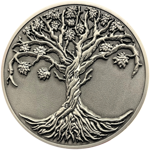 Silver metal coin showing Tree of Life