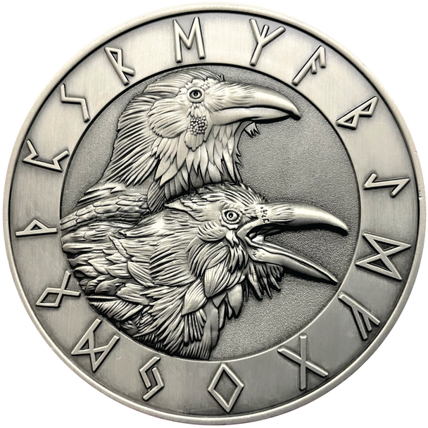 Silver metal coin showing Ravens and runes