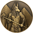 Gold metal coin showing Anubis next to pyramids