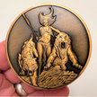 Copper metal coin in hand showing Huntress