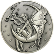 Silver metal coin showing fairy sitting on moon