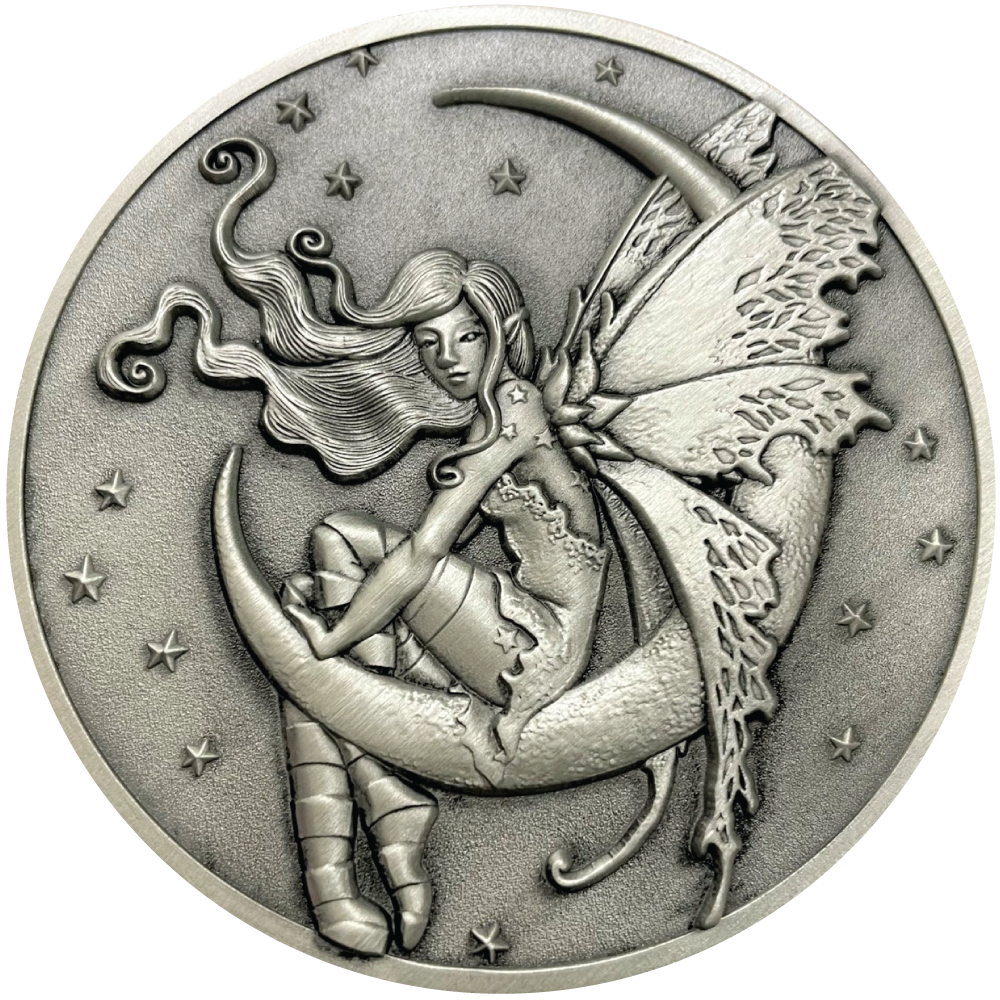 Silver metal coin showing fairy sitting on moon