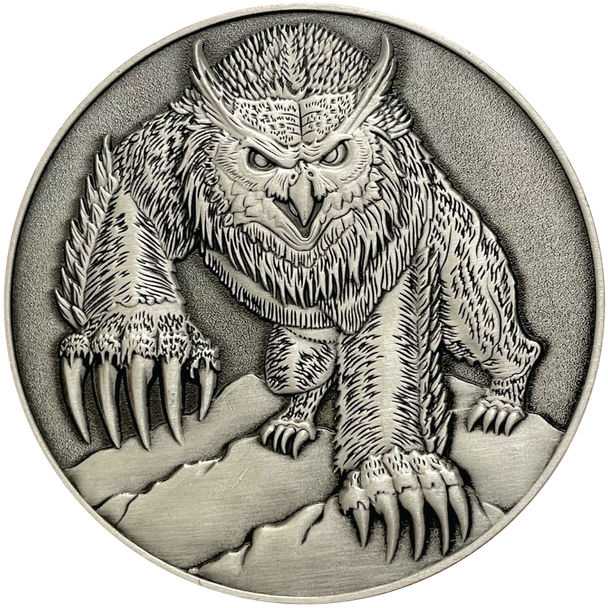 Silver metal coin showing Owlbear