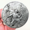 Silver metal coin showing Warrior with Ball and Chain